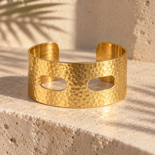 Thread Count 24 mm hand-hammered gold cuff on travertine, two oval scarf slots through the face