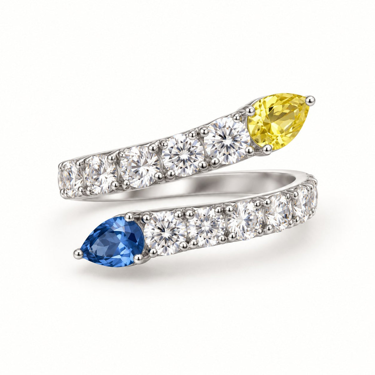 Opposites Attract bypass ring with yellow and blue pear-cut stones and pave band