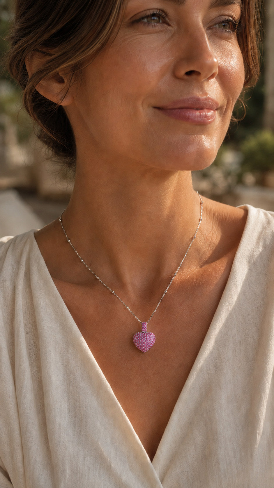 Be Still My Heart pink heart pendant worn on model at accurate scale
