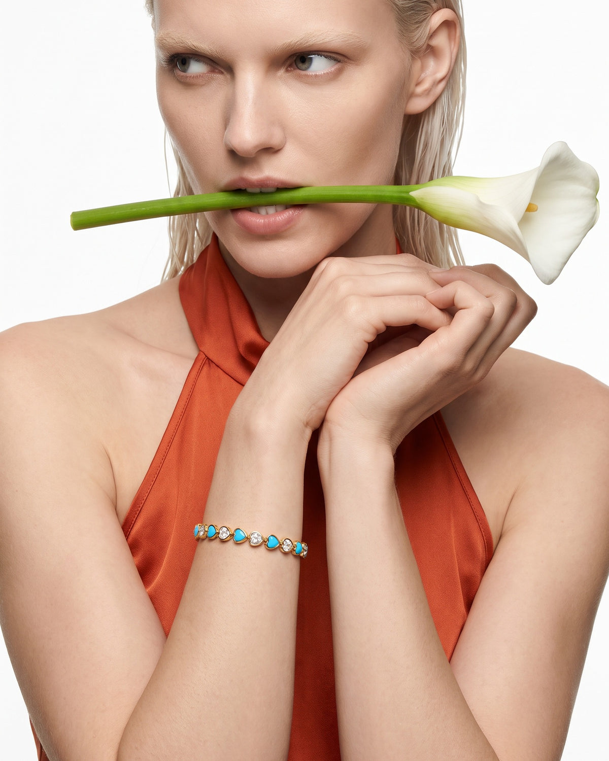 Heart Throb Tennis turquoise heart bracelet on model with calla lily