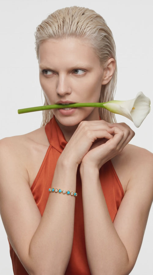 Heart Throb Tennis turquoise heart bracelet – model with calla lily